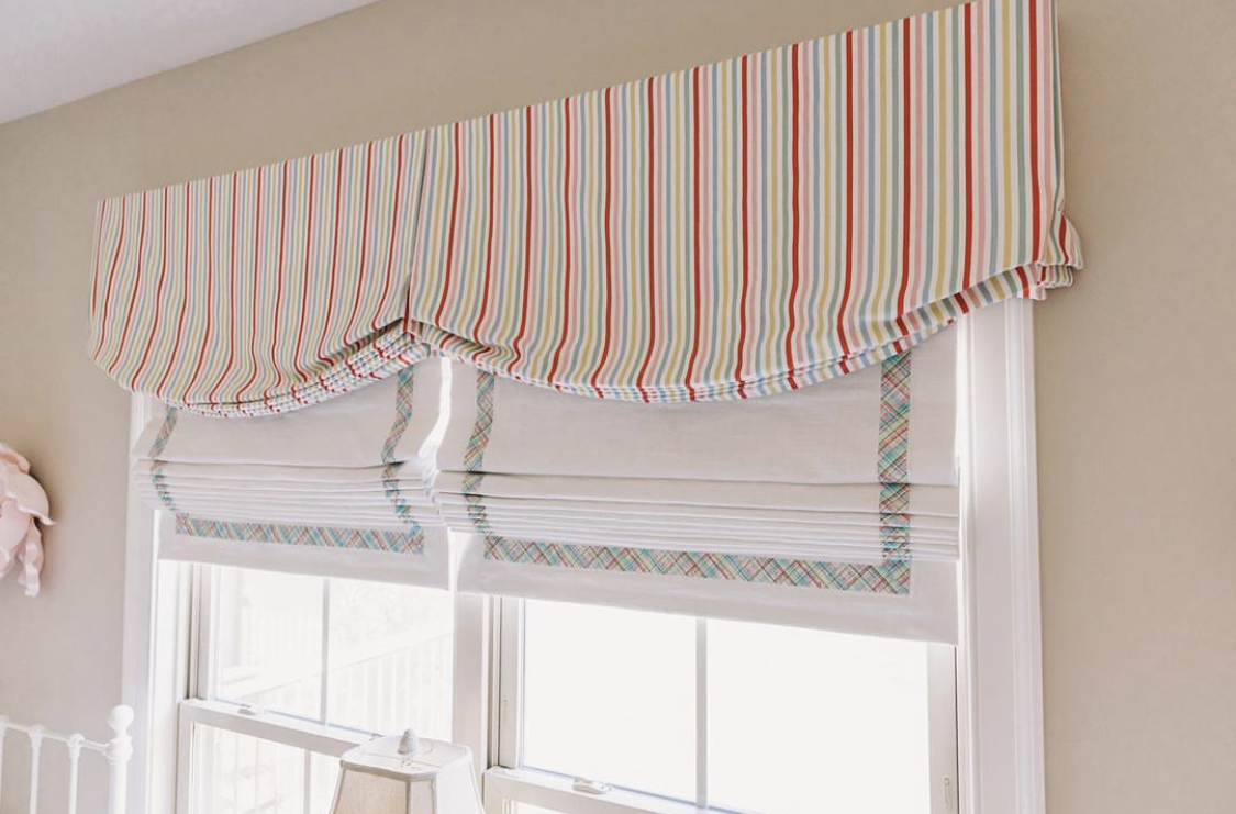 A striped valance decorating the top of a window